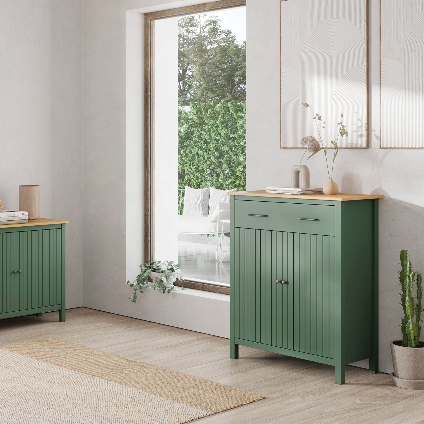 A pair of sage green wooden sideboards in a bright, modern room. One is a three-drawer cabinet with a light wood top, and the other is a two-door cabinet with a matching light wood top.