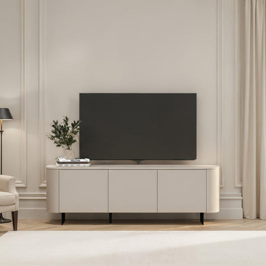 Modern living room with a television on a white cabinet, light-colored walls, and a window with curtains.