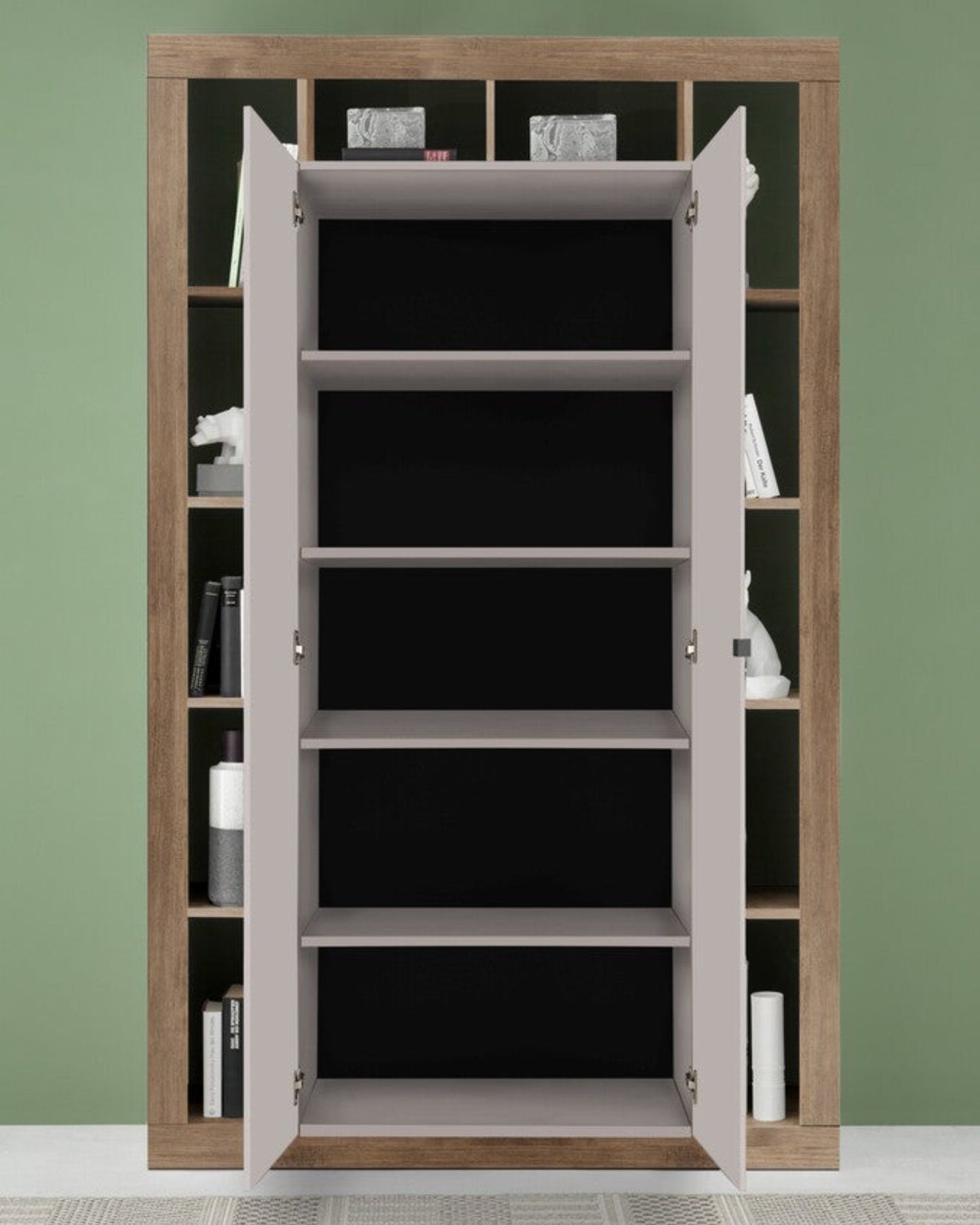 Wooden bookshelf with open doors against a green wall