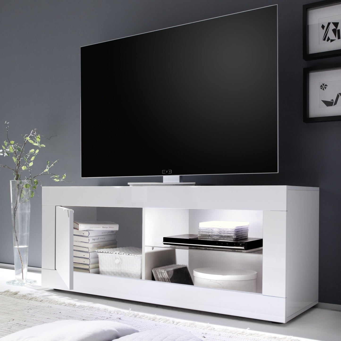 Modern white TV stand with a television mounted on a dark gray wall.