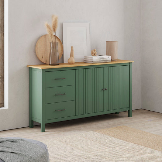 A pair of sage green wooden sideboards in a bright, modern room. One is a three-drawer cabinet with a light wood top, and the other is a two-door cabinet with a matching light wood top.