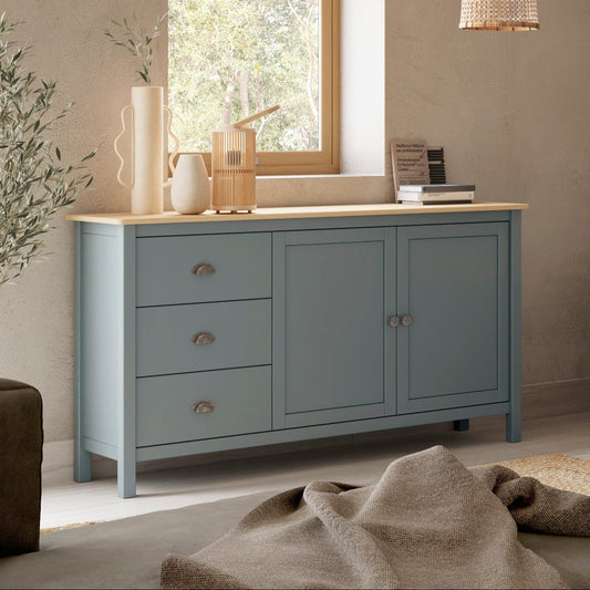 A styled interior room showing a light blue painted wooden cabinet with a light wood top, a matching TV stand, and a wall-mounted television in a rustic living room setting.