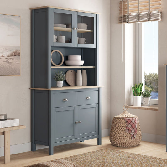 Two blue cabinets in a room with windows and decor