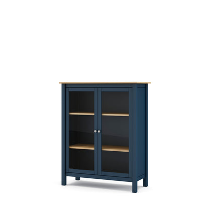 A navy blue storage cabinet with two glass doors, two wooden shelves, and a light natural wood top and shelf edges, shown on a plain white background.