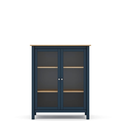 A navy blue two-door cabinet with glass doors, light wood shelves, and a light wood top, shown against a plain white background.