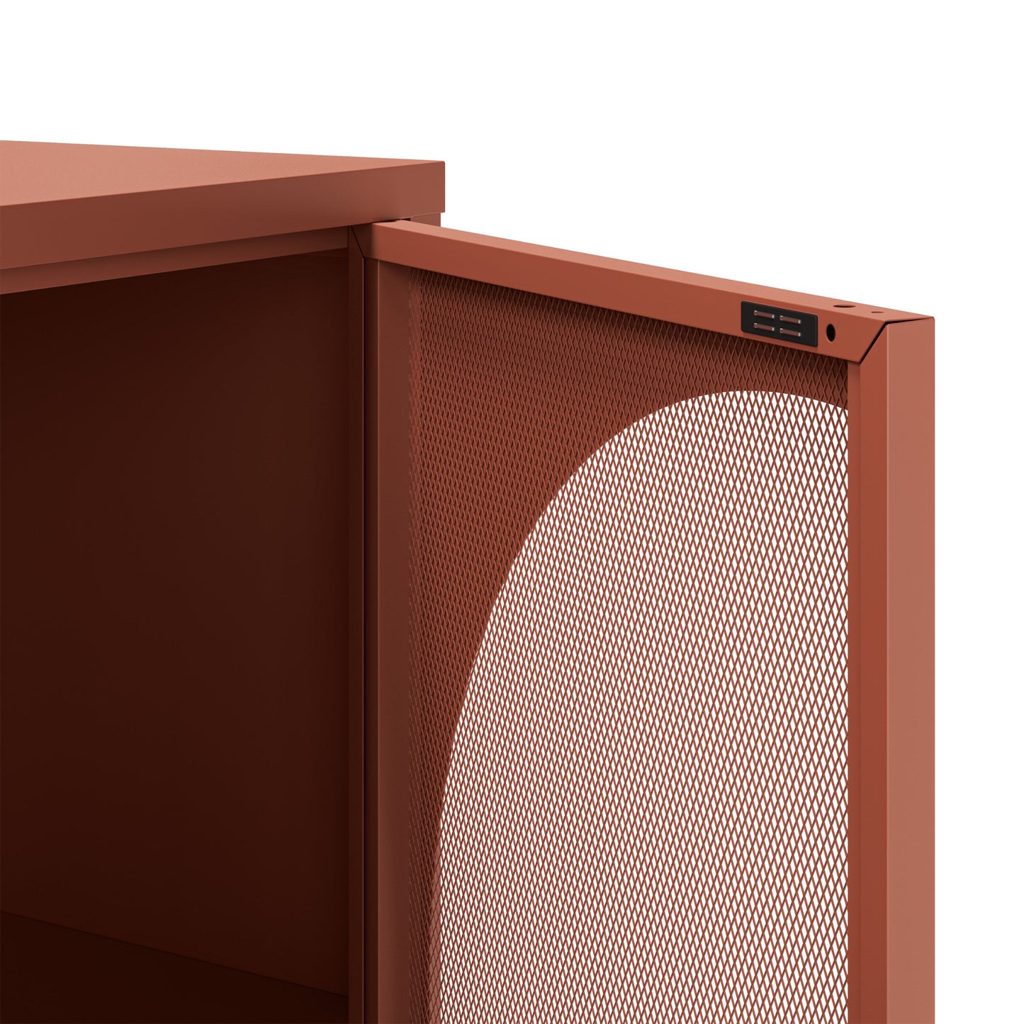 Close-up of a modern storage cabinet or shelf with a terracotta rust finish, featuring a perforated metal front panel and a small black control or label plate near the top edge.