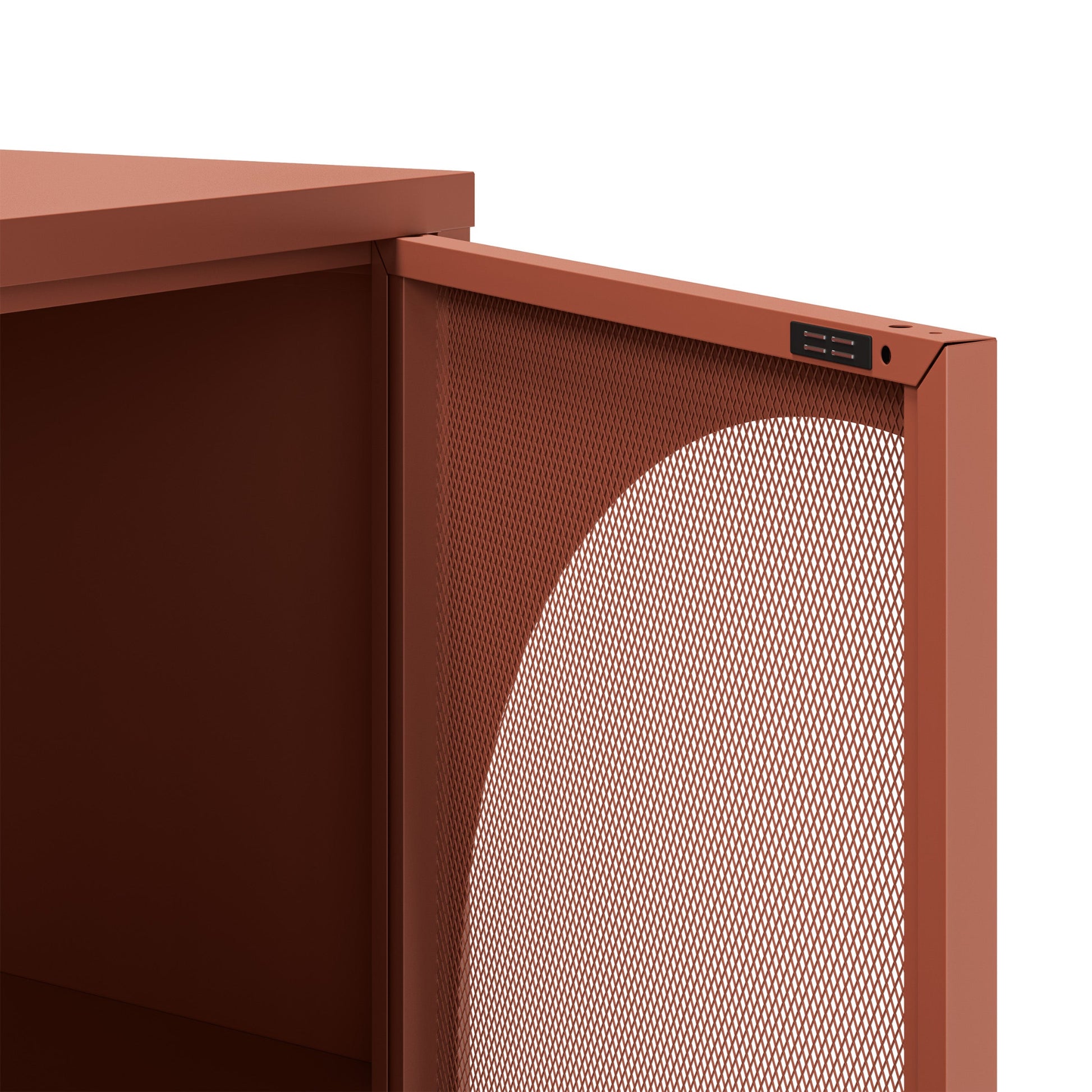 Close-up of a modern storage cabinet or shelf with a terracotta rust finish, featuring a perforated metal front panel and a small black control or label plate near the top edge.