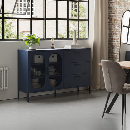 A navy blue wooden sideboard cabinet with two glass-front doors and three drawers, styled in a modern loft room next to a dining table and chair.