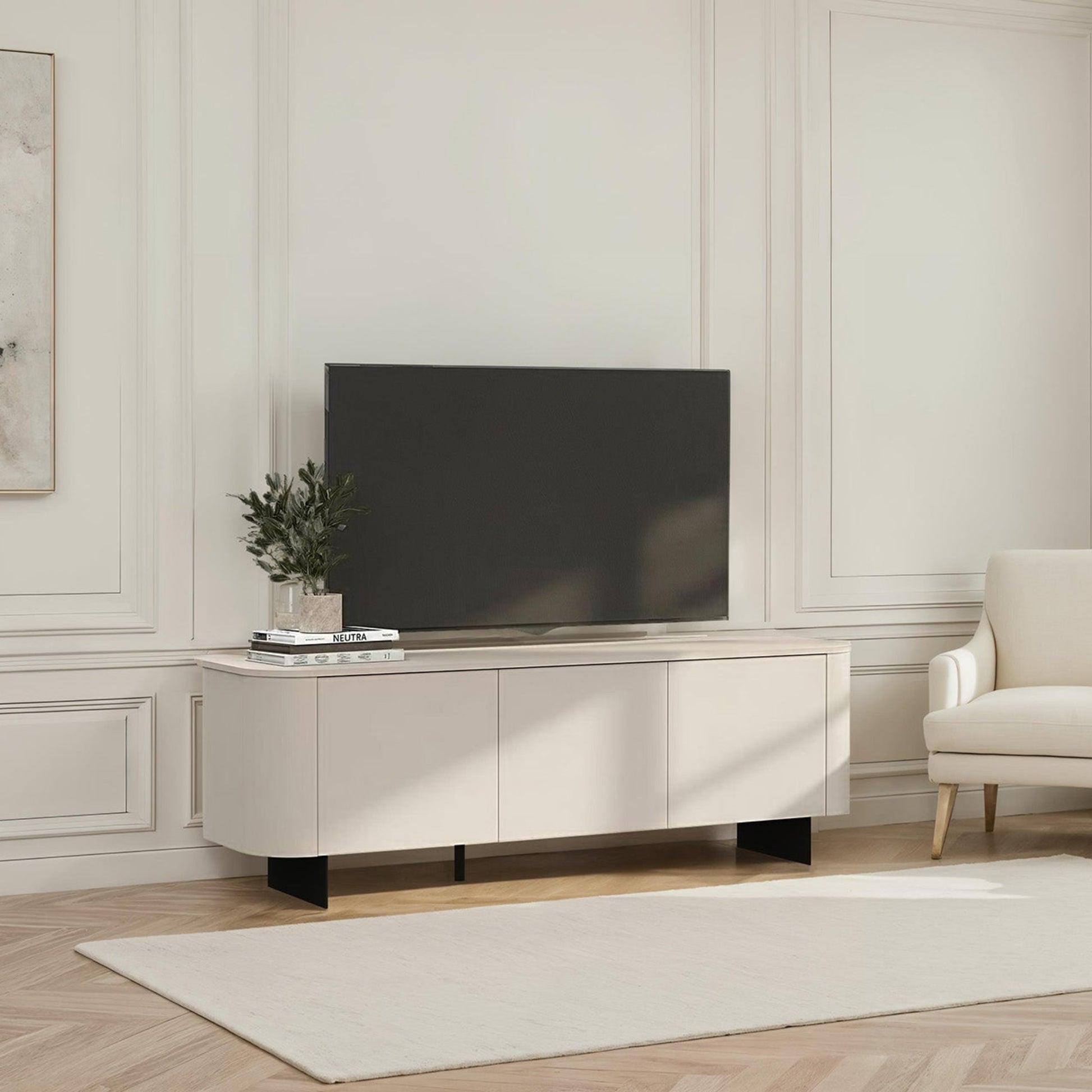 Modern living room with a television on a wooden stand, a chair, and decorative elements.
