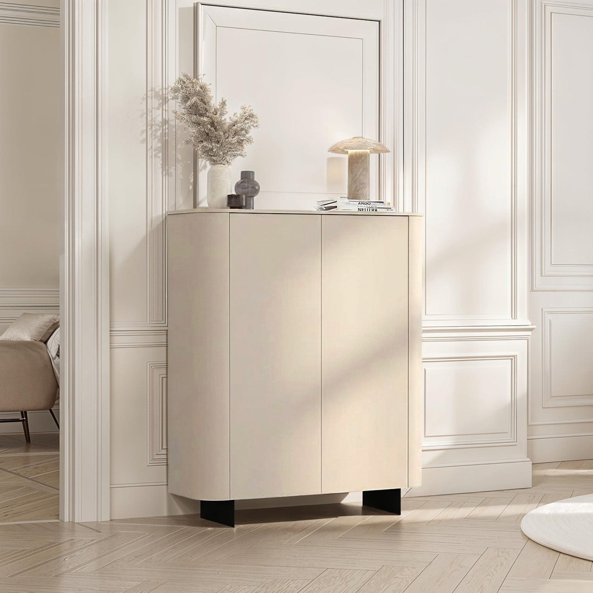 Modern interior design with a cream-colored cabinet and chair in a well-lit room.