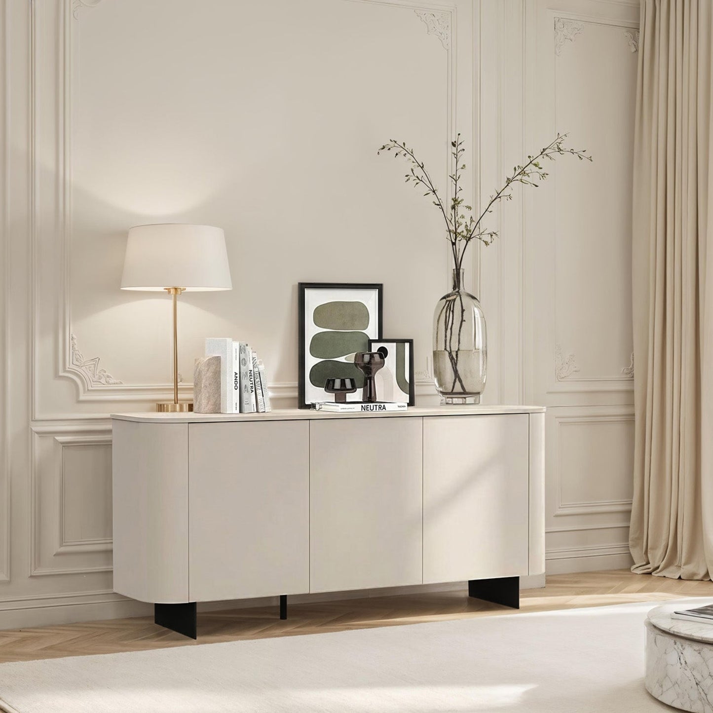 Modern living room with a white sideboard, lamp, and decor items.