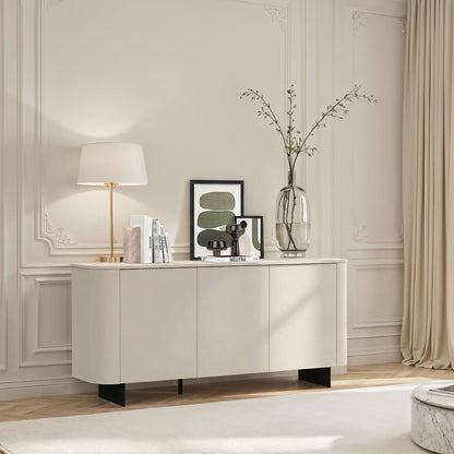 Modern living room with a white sideboard, lamp, and decor items.