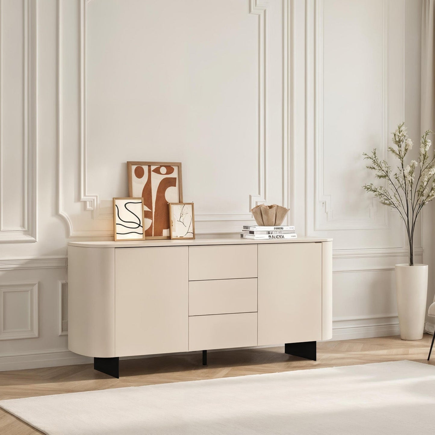 Beige sideboard in a modern living room with decor items and a chair.