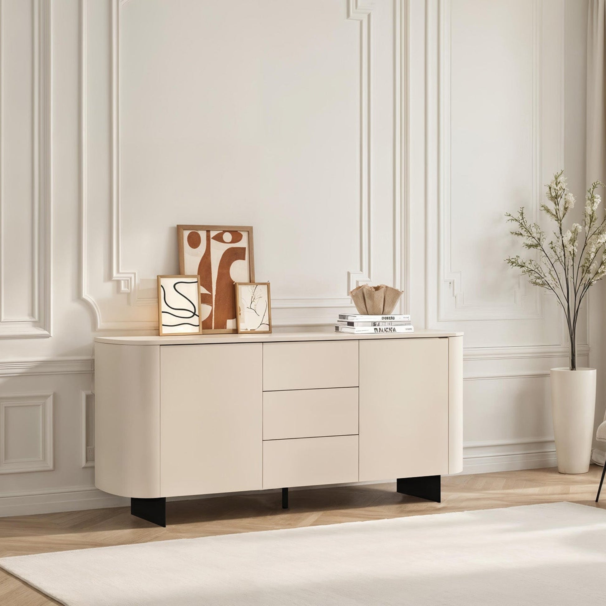 Beige sideboard in a modern living room with decor items and a chair.
