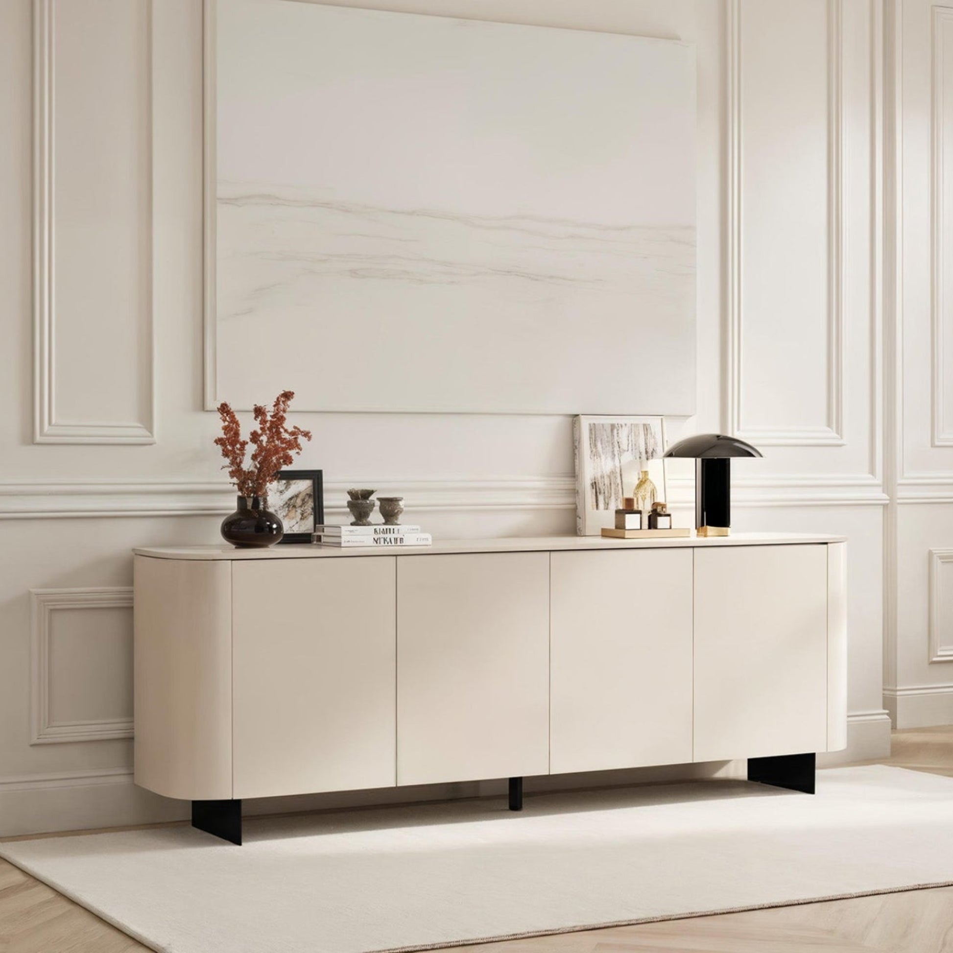 Modern living room with a white sideboard, chair, and decorative items.
