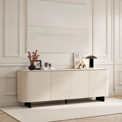 Modern living room with a white sideboard, chair, and decorative items.