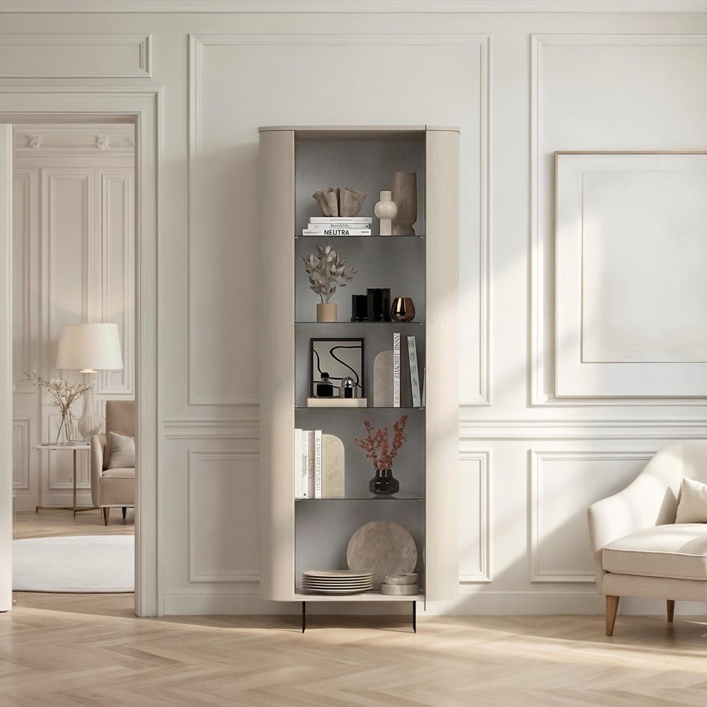 Modern interior design with a bookshelf, armchair, and decorative items in a well-lit room.