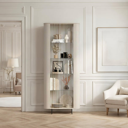 Modern living room with a white armchair, bookshelf, and decorative items.