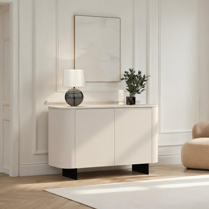 Modern interior with a white cabinet, beige armchair, and decorative items.
