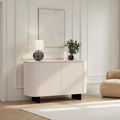 Modern interior with a white cabinet, beige armchair, and decorative items.