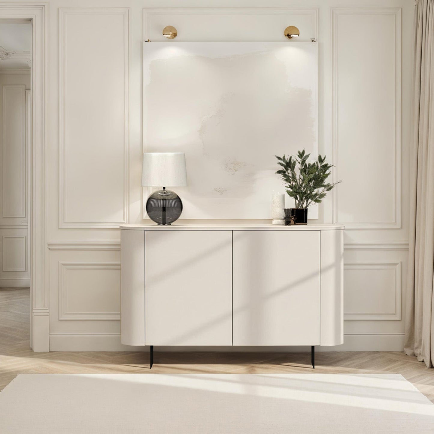 Modern interior with a white console table, lamp, and plant against a neutral wall.