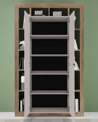 Wooden bookshelf with open doors against a green wall
