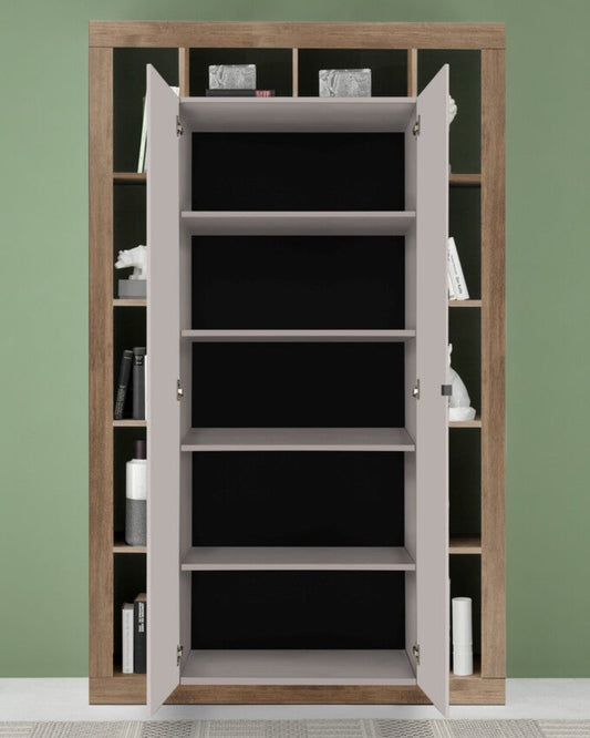 Wooden bookshelf with open doors against a green wall