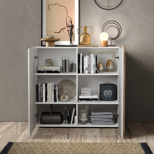 White bookshelf with decorative items against a gray wall
