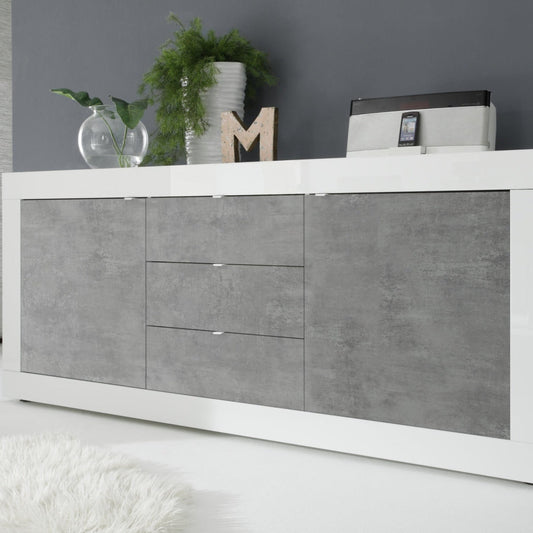 Modern white and gray sideboard with decorative items against a gray wall.