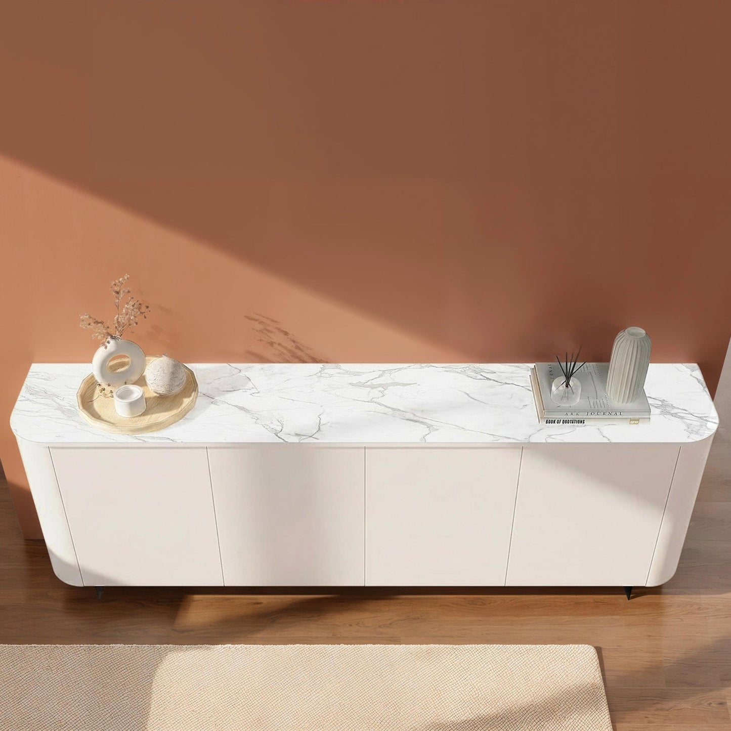 White marble-patterned sideboard against a pink wall
