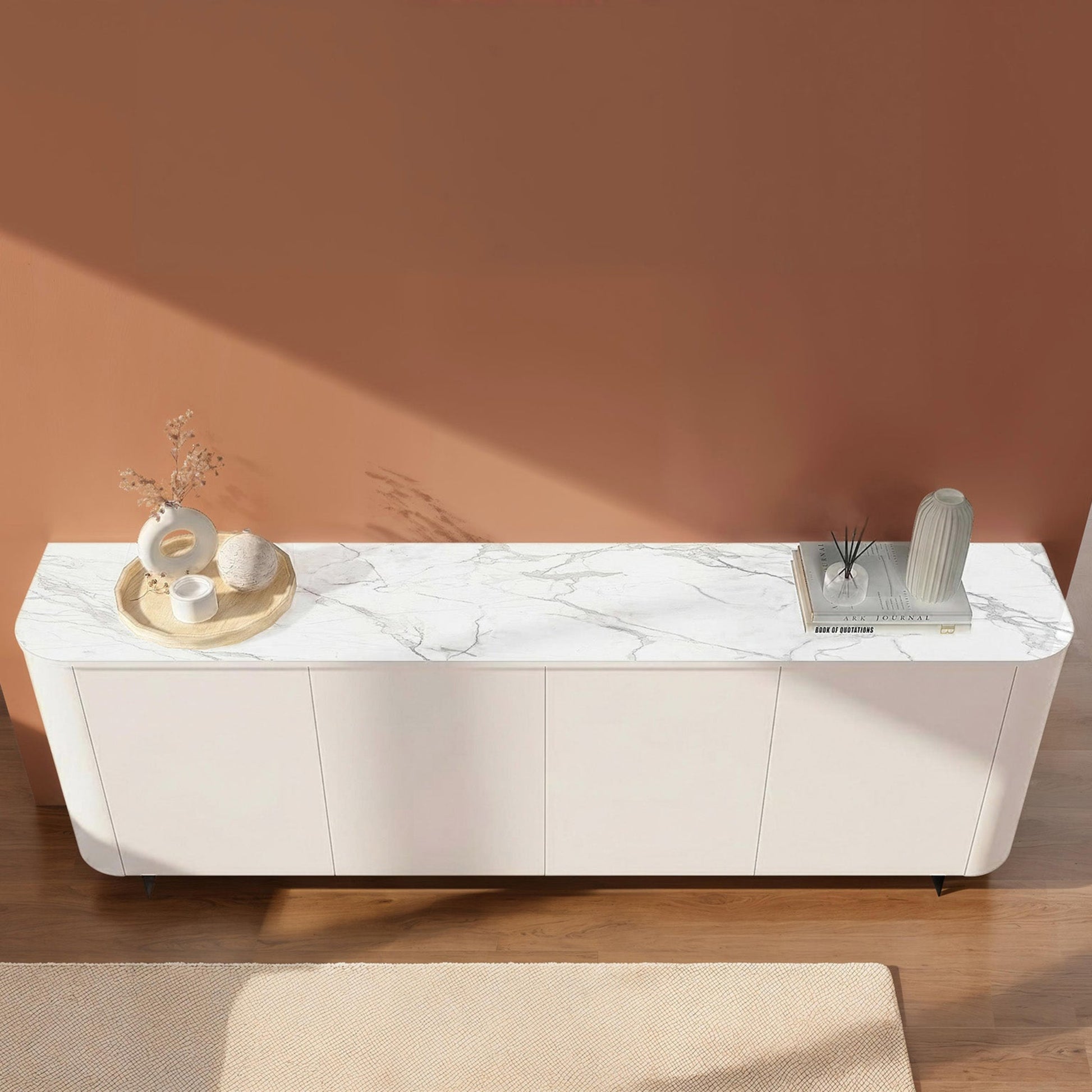 White marble-patterned sideboard against a pink wall