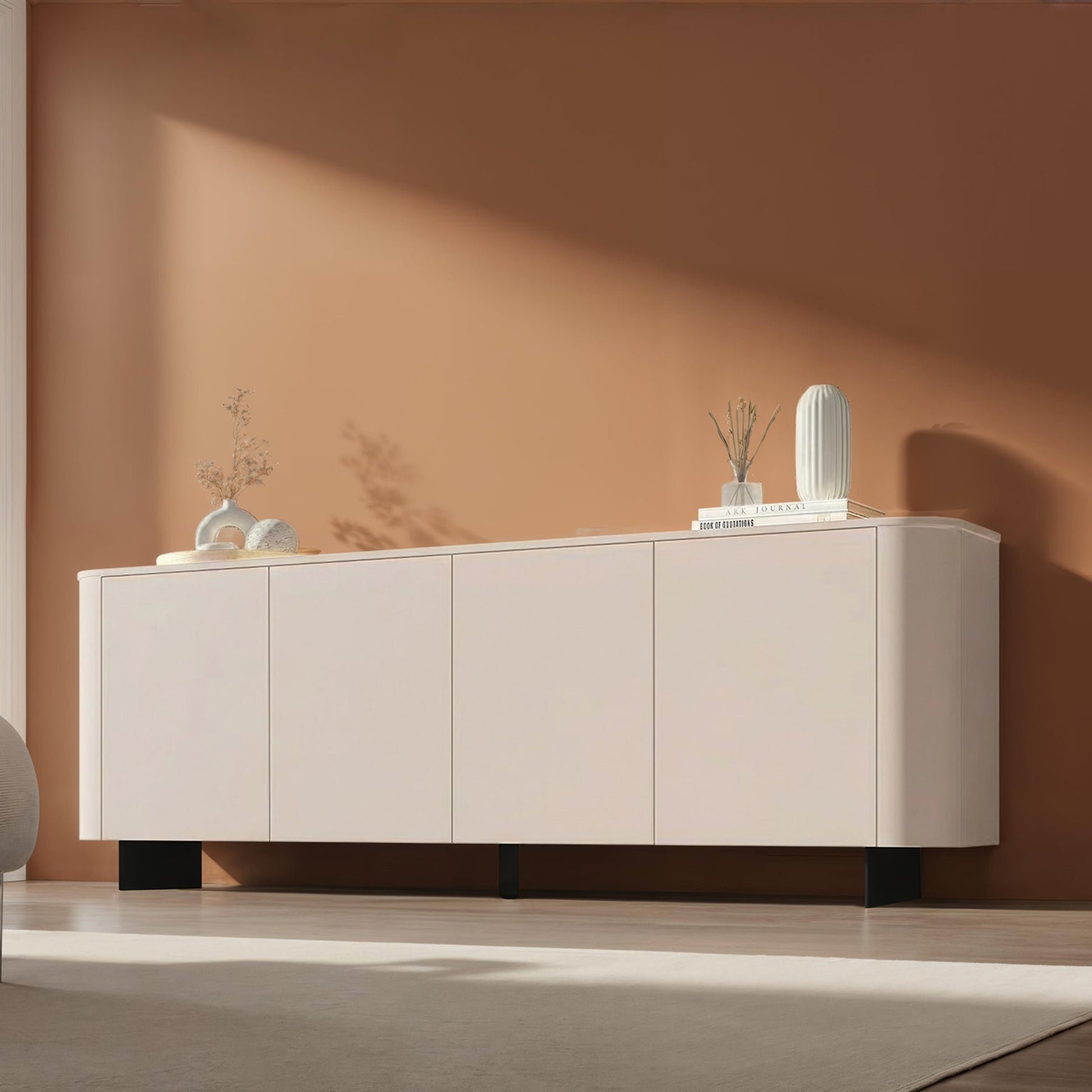 Beige sideboard against a brown wall with decorative items