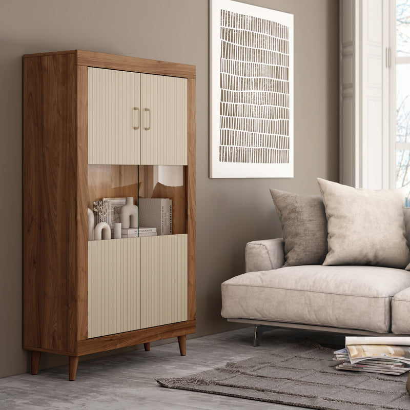 A mid-century modern wooden cabinet with cream ribbed doors and gold handles, styled in a living room next to a beige sofa.