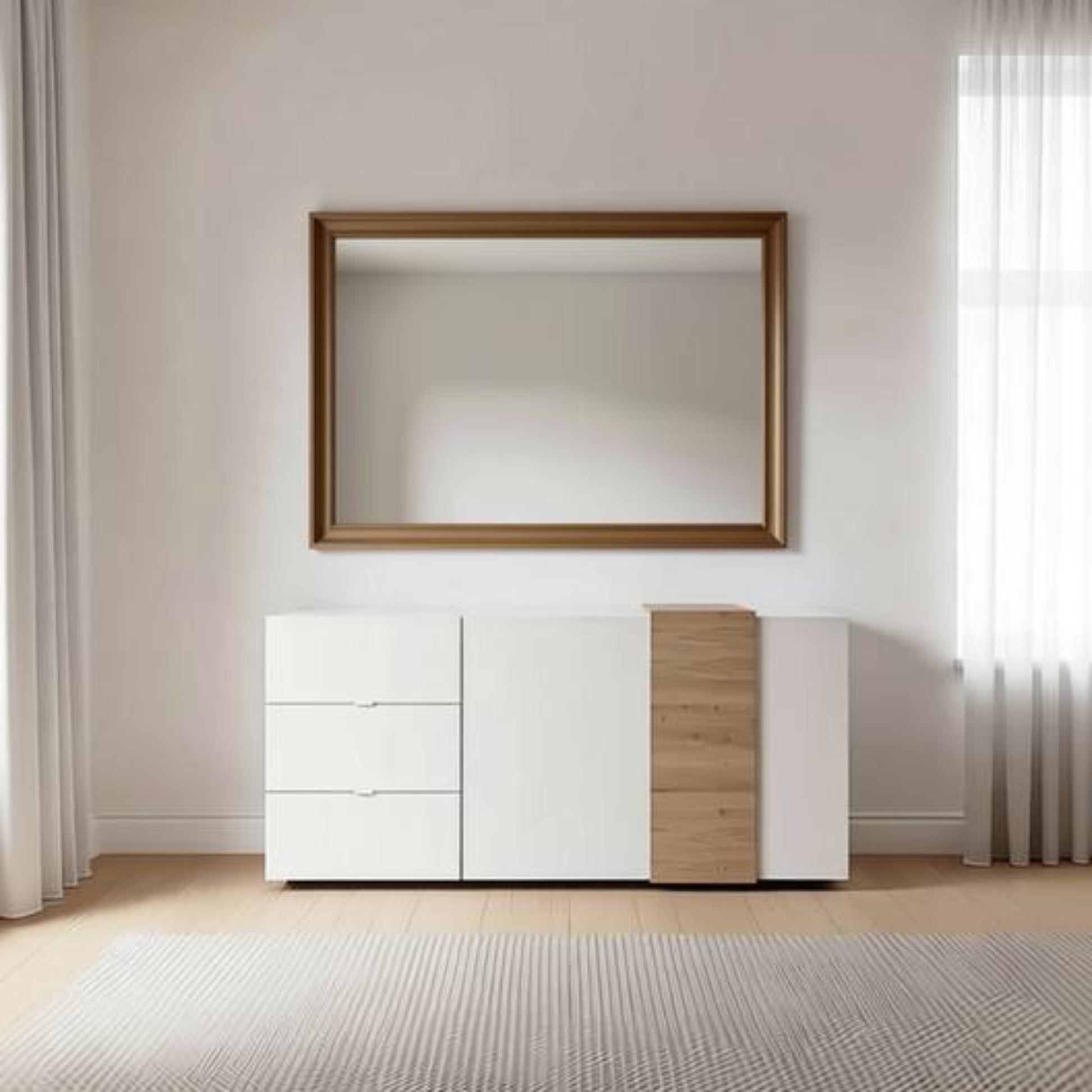 A modern white and light wood credenza with a matching rectangular wall mirror, styled in a minimalist room with a textured rug and sheer curtains.