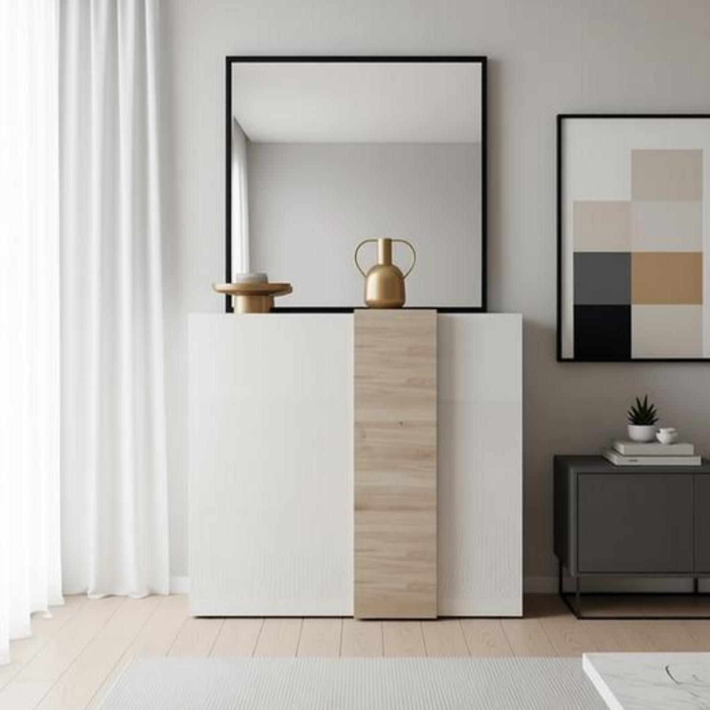 A modern white and light wood cabinet with a large black-framed mirror on top, styled in a minimalist living room with a gray wall, white curtains, and a gray sideboard.