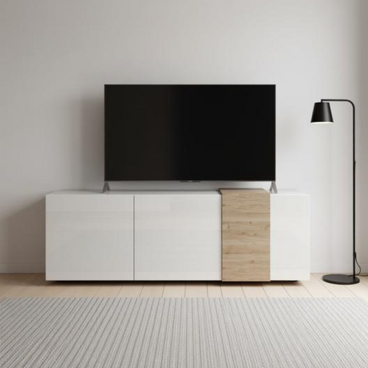A modern white and light wood TV stand cabinet with a black flat-screen television mounted above it, set against a minimalist light gray wall with a black floor lamp to the right.